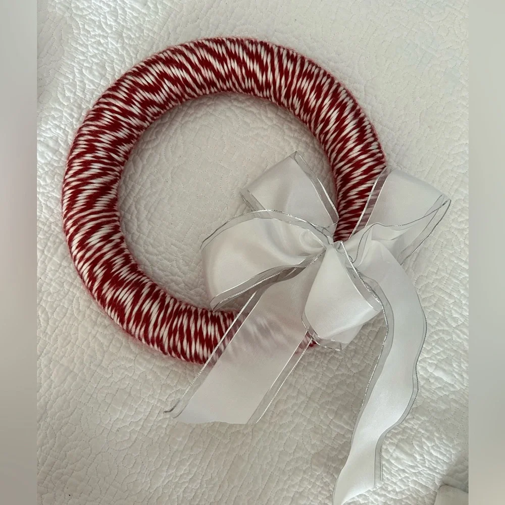 Red & white Candycane style Wreath. White bow accent. Approx 12”. Ready to hang.